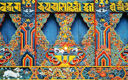 Bhutanese handicraft art: Intricate, colorful wood carvings with cultural symbols. About Bhutan tourism & traditional art.