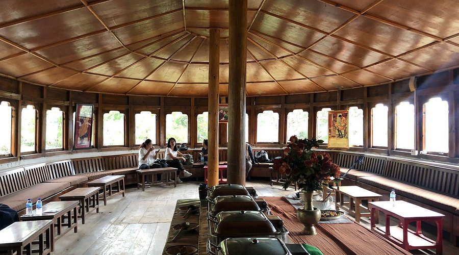 Interior of Tiger's Nest hike stop, Bhutan, with wooden architecture, buffet, seating, and natural light from windows.